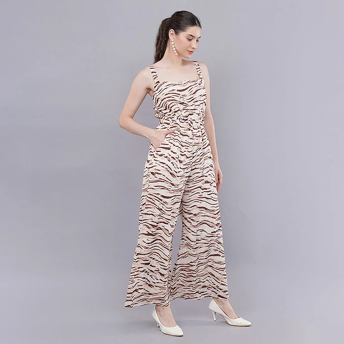Indian female model in a beige and black tiger stripe print wide-leg jumpsuit with nude heels posing full length on a grey seamless backdrop under soft studio light, a fit-focused image for a+ module images