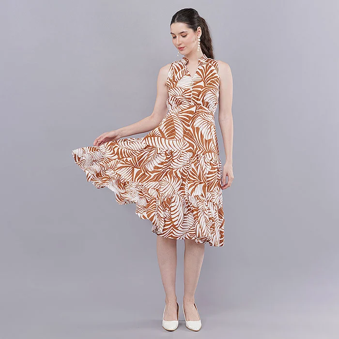 Indian female model in a rust and white tropical leaf print midi dress holding the flared hem, full-length pose on a soft grey seamless studio backdrop with even softbox lighting, the kind of on-model catalogue image a new seller prepares after Meesho seller registration