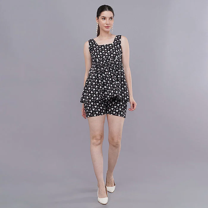 Full-length front view of an Indian female model in a black and white polka dot co-ord top and shorts with white heels on a light grey studio backdrop, a consistent catalogue frame that helps avoid a myntra catalogue rejection