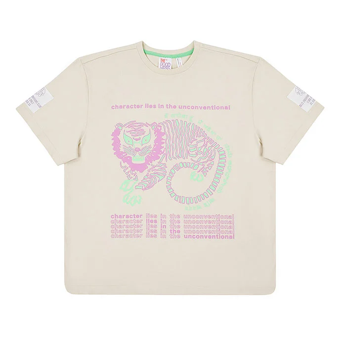 Cream kids' oversized t-shirt with a pink and green illustrated print photographed straight on against a pure white background, a centred product-only garment image with even lighting and no shadows