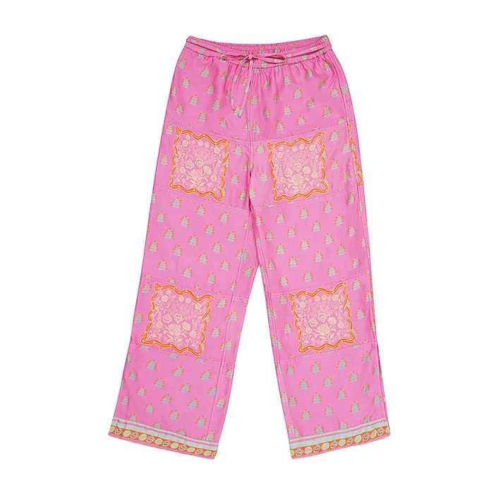 Flat lay product photo of pink printed palazzo pants with orange block print patches and a drawstring waist on a white background, top-down catalogue image showing true length and print placement to prevent Meesho wrong product returns