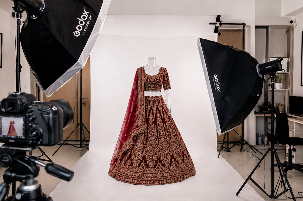 Professional ghost mannequin photography of deep red bridal lehenga with gold zardozi embroidery, floating 3D hollow neck effect on white background, luxury Indian bridal wear ecommerce catalog photography by Uniqs Studio Delhi NCR