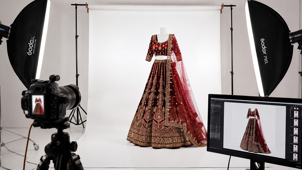 Behind the scenes bridal ghost mannequin photography setup with softbox lighting DSLR camera and heavy embroidered lehenga on invisible mannequin at Uniqs Studio Delhi NCR studio