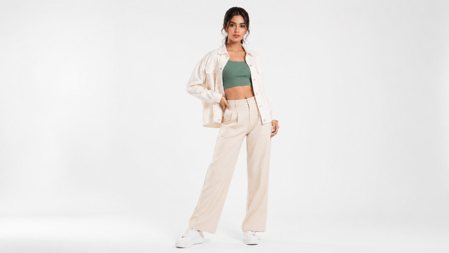 Fashion photography for ecommerce shoot with a model in styled outfit under soft studio lighting on a clean white cyclorama background