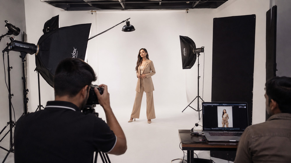 Wide cyclorama studio setup for fashion model photography shoot with professional strobe lighting, softboxes and seamless white backdrop, controlled campaign photography environment in Delhi NCR