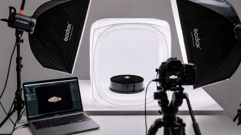 Professional motorised turntable jewellery photography setup with diamond ring under softbox lighting and light tent for 360 degree ecommerce spin video production