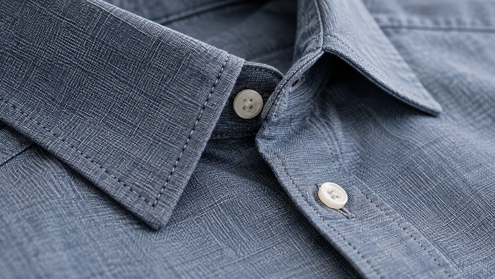 Behind the scenes of amazon fabric close-up photography showing detailed shirt buttons, stitching, woven textile pattern