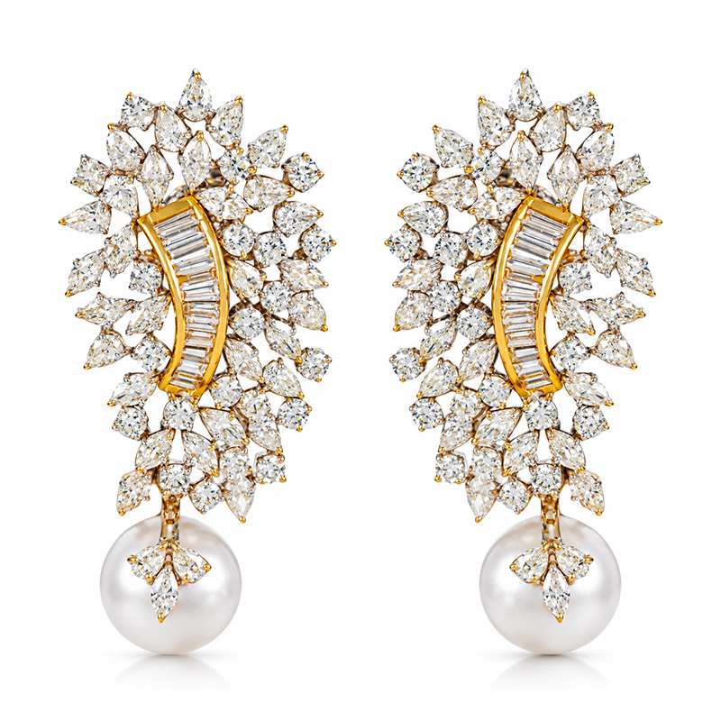 Gold crystal pearl drop earrings on a white background